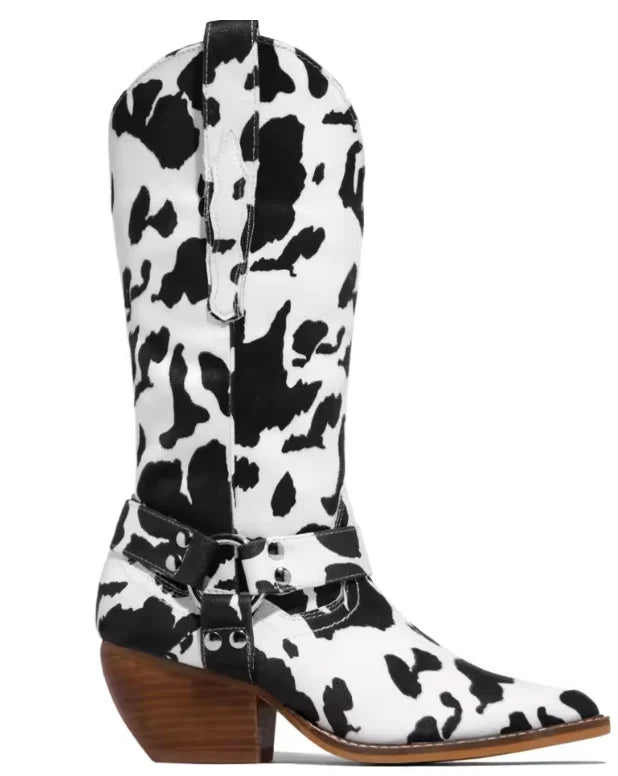 Full-length view of black and white cow print cowboy boots with pointed toe