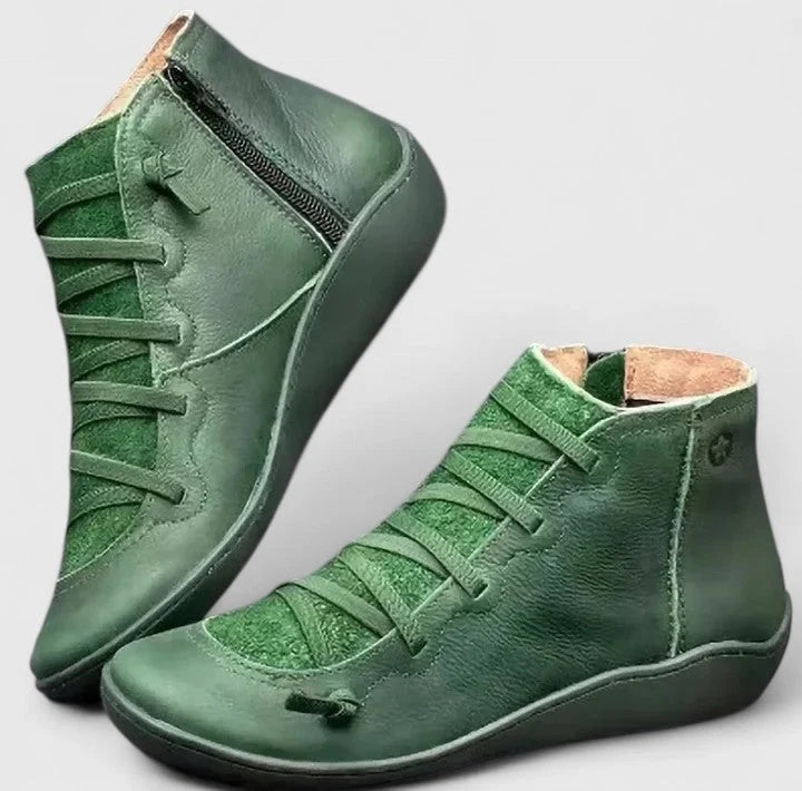 Side angle of women's ankle boots featuring arch support construction and cushioned footbed