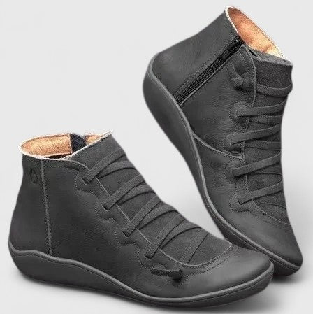 Pair of women's ankle boots in tan displaying side zip fastening and lace-up detailing