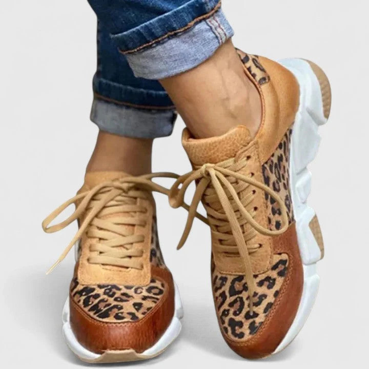 Side view of women's chunky sole trainers with animal print pattern and tan panels