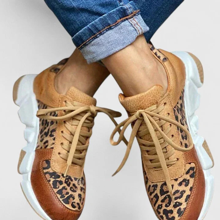 Women's leopard print trainers with padded collar and white platform sole from rear angle