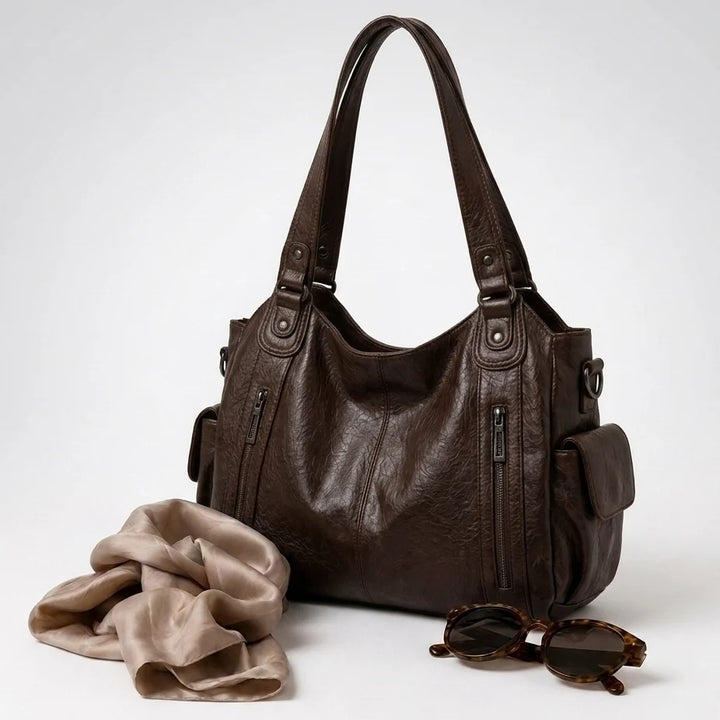 Pojemna torba crossbody z wygodnymi uchwytami i opcjonalnym paskiem do noszenia na skos