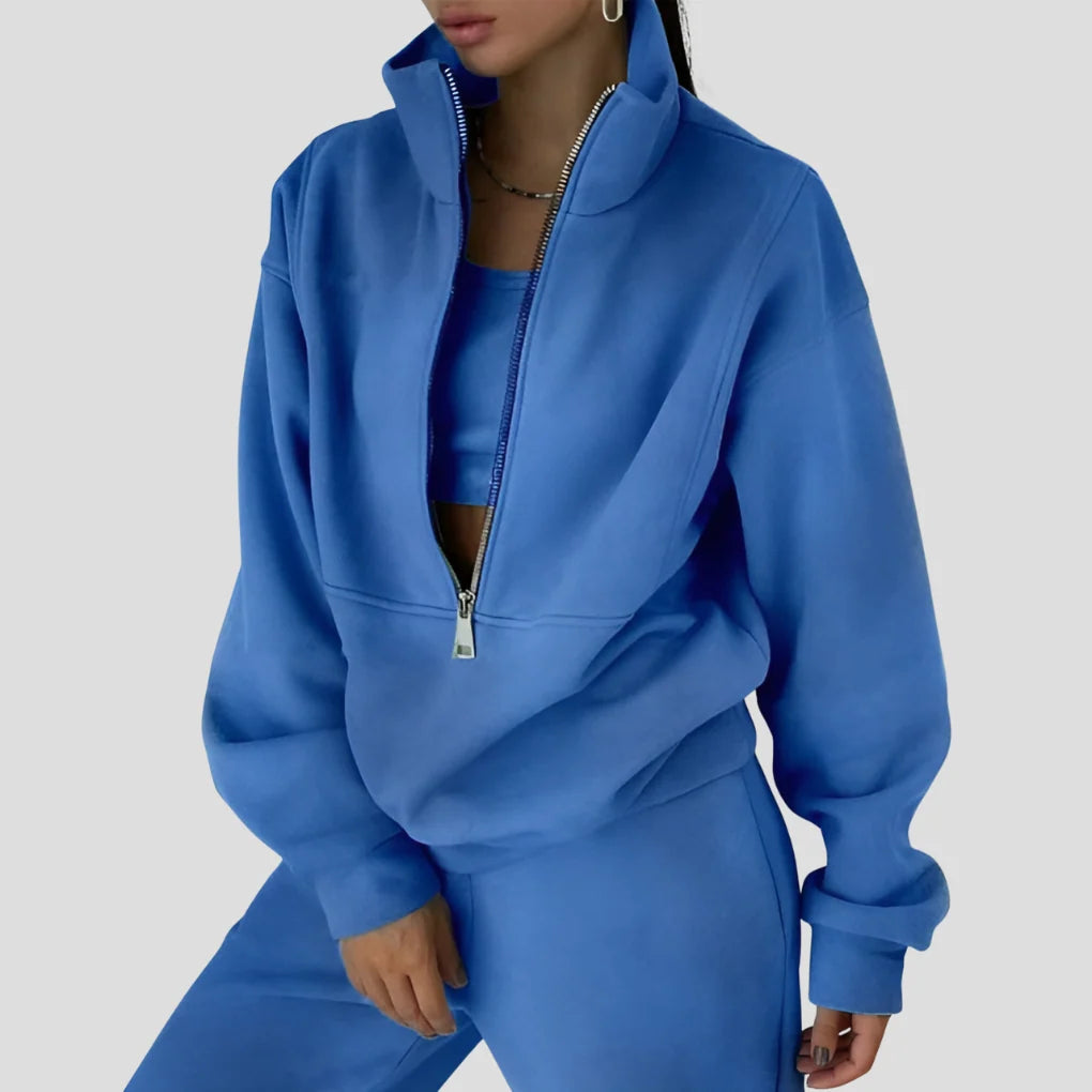Dwuczęściowy dres damski w kolorze szaroniebieskim z zamkiem z przodu bluzy i luźnymi spodniami joggerami