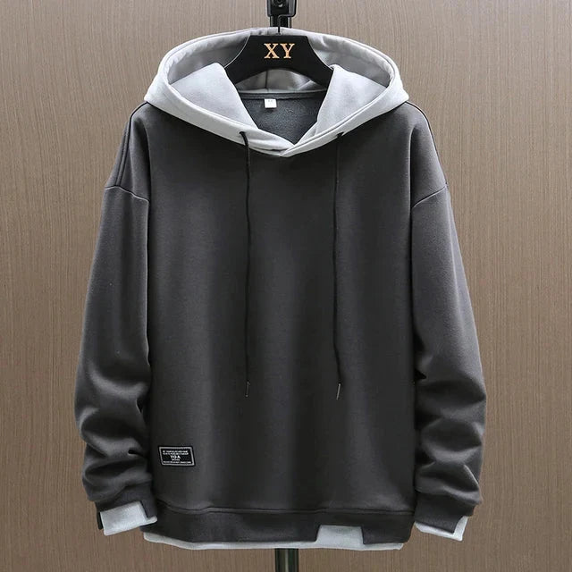 Męski dwukolorowy casualowy hoodie w luźnym kroju z kontrastującymi kolorami na korpusie i rękawach