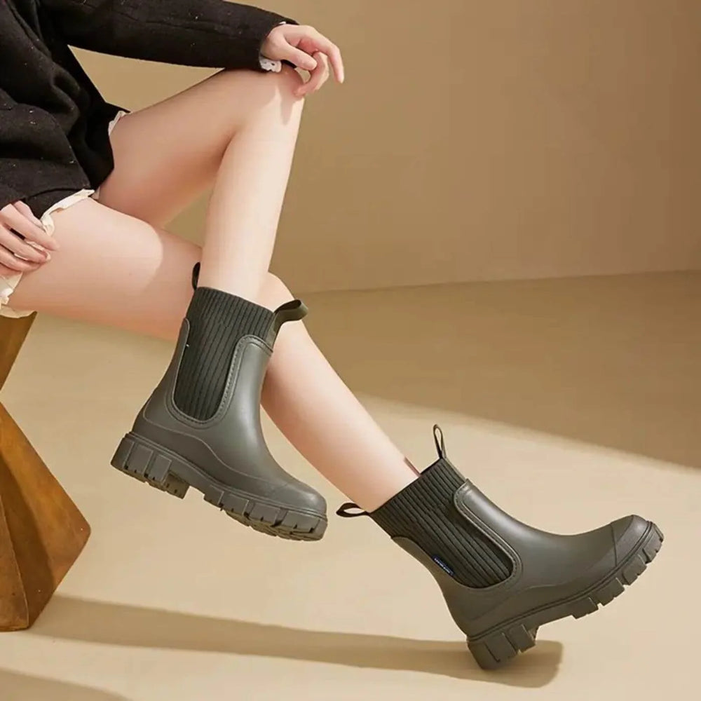 Side view of women's waterproof Chelsea boots showing smooth upper and dual fabric pull tabs