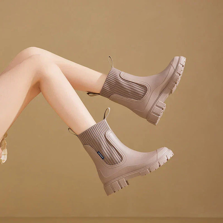 Rear view of women's Chelsea boots highlighting heel pull tab and deep-lugged outsole tread