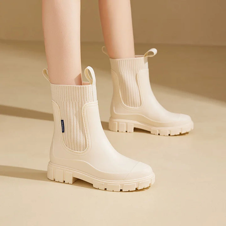 Women's Chelsea boots paired with casual outfit demonstrating ankle-height fit and versatile styling