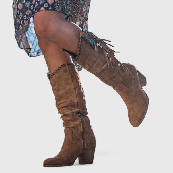 Side view of mid-calf cowboy boots showing decorative fringe detail and suede-effect finish