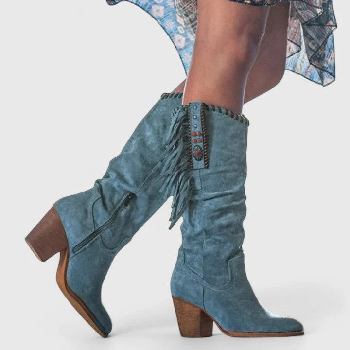 Close-up of embroidered trim and beaded accent on burgundy cowboy boot shaft