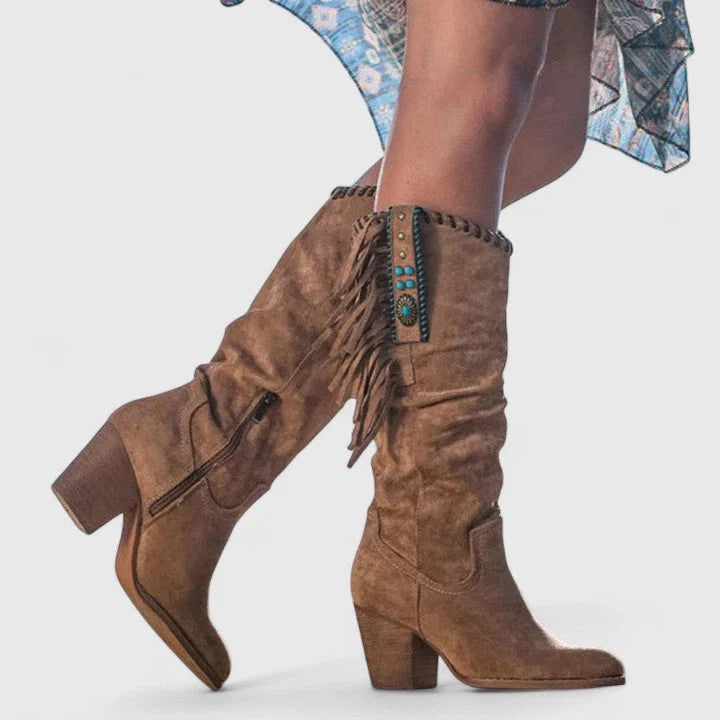 Detail shot of decorative fringe and western-style stitching on mid-calf boots