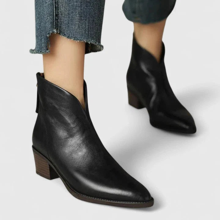 Side profile of women's ankle boots with sleek silhouette and rear zip