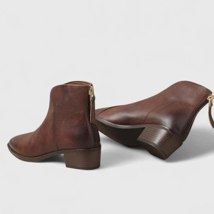 Side view of women's ankle boots showing rear zip fastening and low block heel