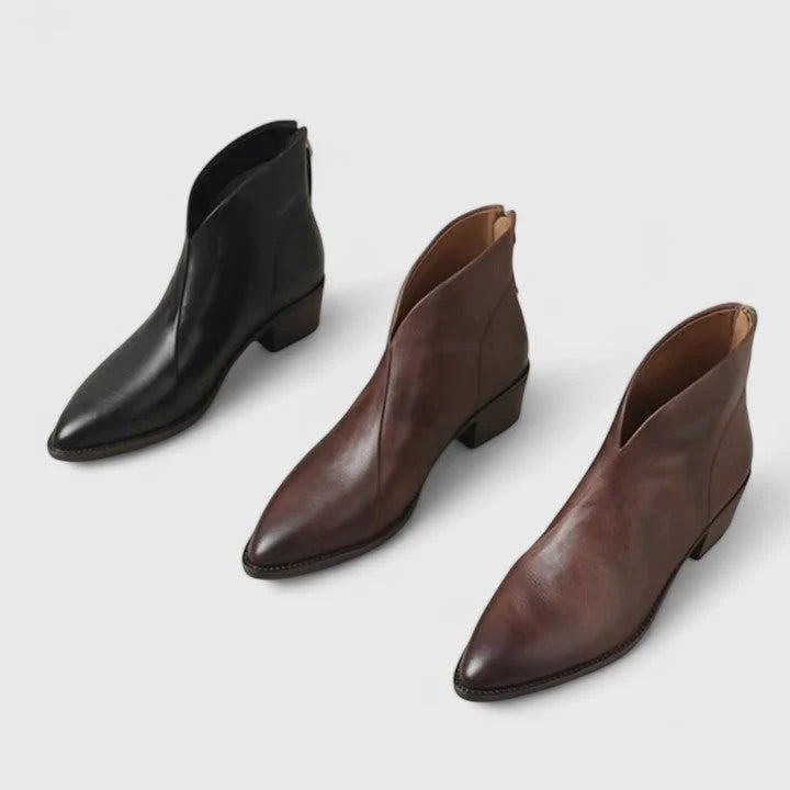 Close-up of pointed toe ankle boots with smooth structured material and block heel