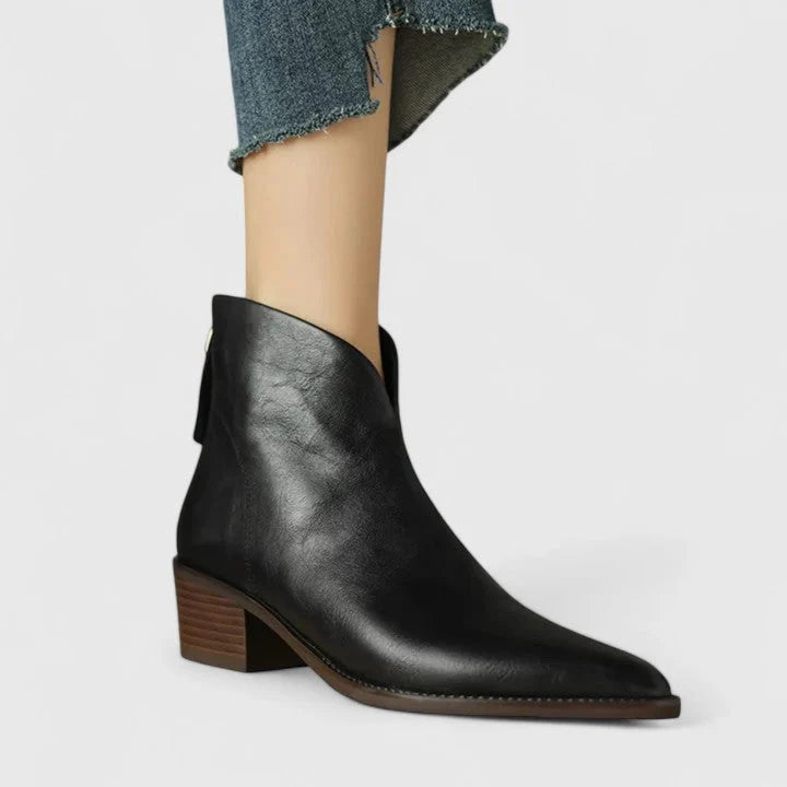 Detail of women's ankle boots showing block heel and smooth finish construction