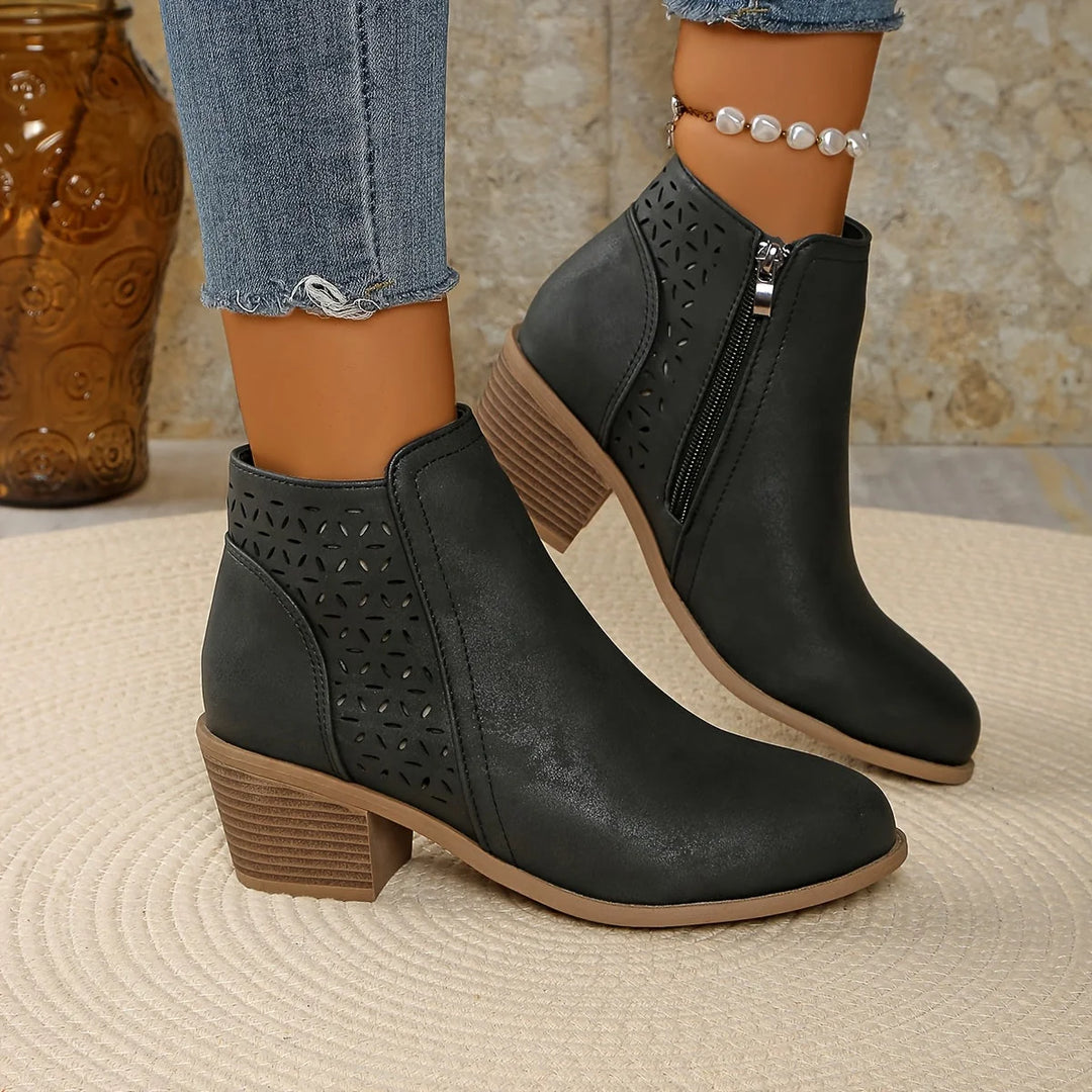Women's ankle boots with block heel and laser-cut detailing, worn with cropped denim jeans