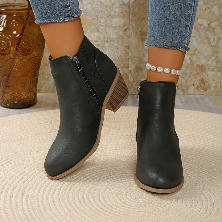 Women's ankle boots in black colourway with side zip and laser-cut detailing