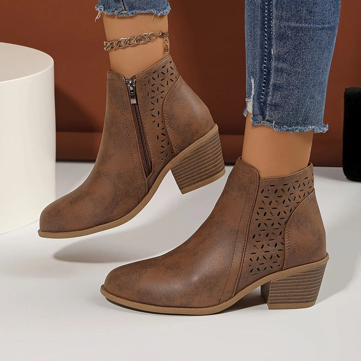 Rear view of women's ankle boots showing stacked heel construction and smooth finish