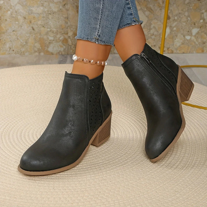 Blue women's ankle boots with laser-cut pattern and side zip fastening detail